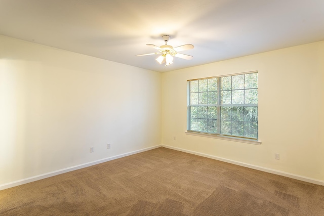 carpeted empty room with ceiling fan