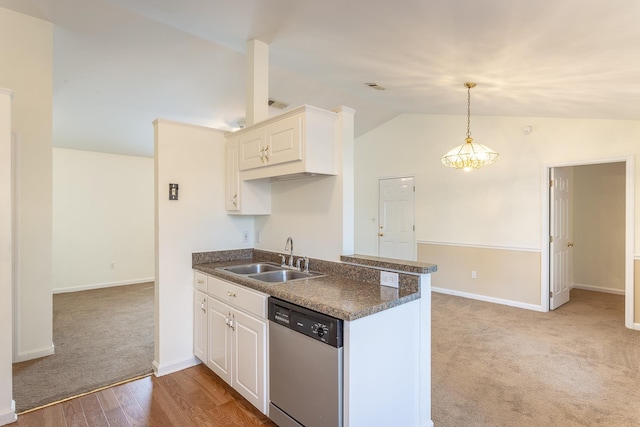 kitchen featuring sink, white cabinetry, decorative light fixtures, vaulted ceiling, and stainless steel dishwasher