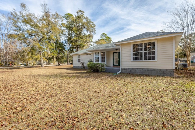 back of property featuring a yard