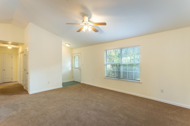 carpeted empty room featuring ceiling fan and lofted ceiling