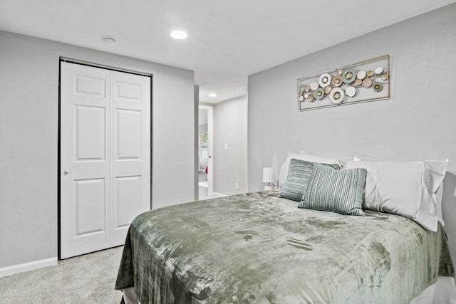 bedroom featuring light carpet and a closet