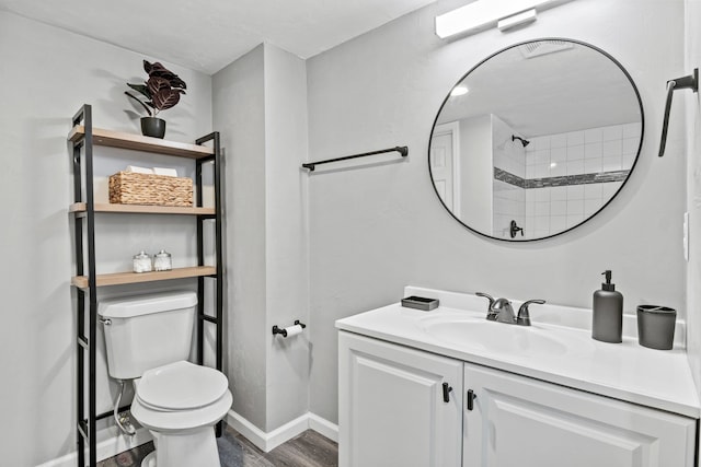 bathroom with vanity, hardwood / wood-style floors, and toilet