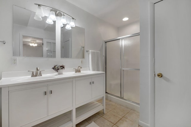 bathroom with ceiling fan, a shower with shower door, tile patterned floors, and vanity