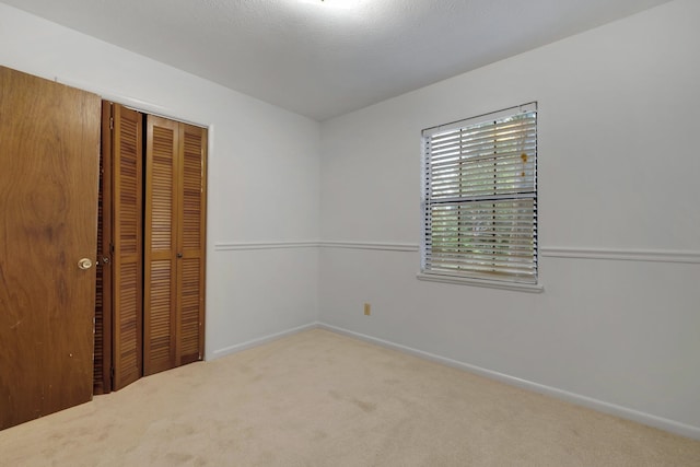 unfurnished bedroom with a closet and carpet floors