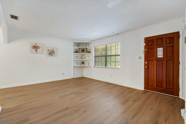 foyer entrance with light hardwood / wood-style floors