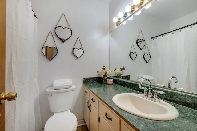 bathroom featuring toilet and vanity