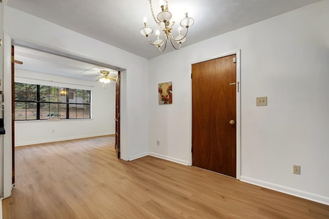 unfurnished room with light hardwood / wood-style floors and ceiling fan with notable chandelier