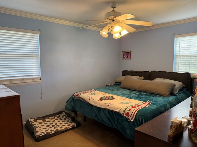 bedroom featuring a ceiling fan, ornamental molding, and carpet flooring