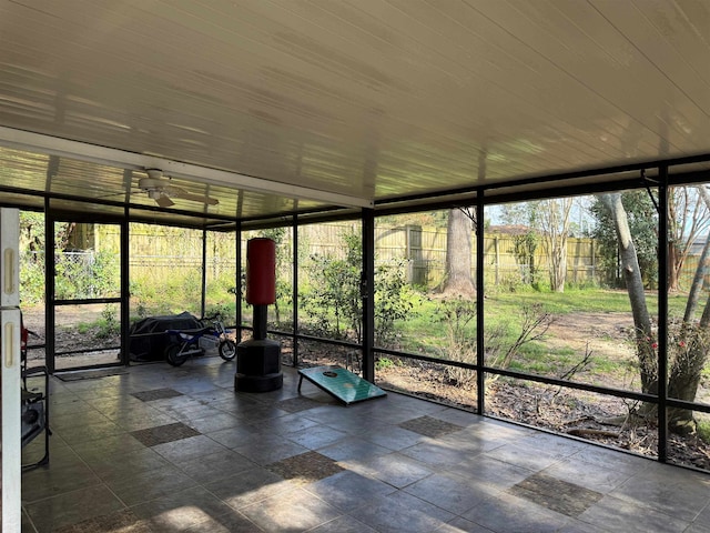 unfurnished sunroom with ceiling fan and wooden ceiling