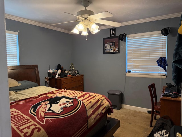 bedroom with ceiling fan, baseboards, ornamental molding, and carpet flooring