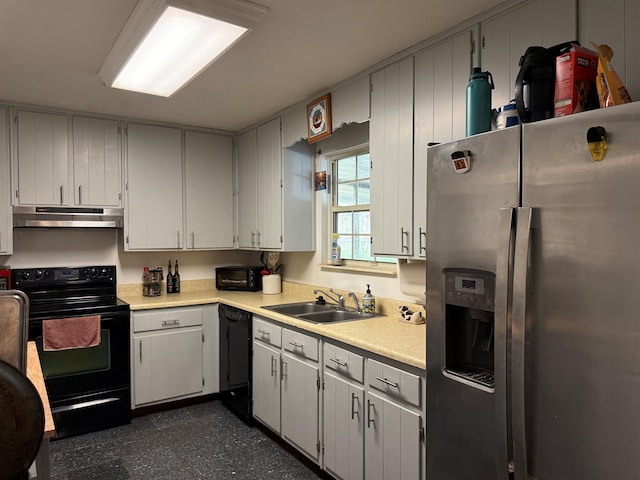 kitchen featuring a sink, black appliances, light countertops, under cabinet range hood, and dark floors