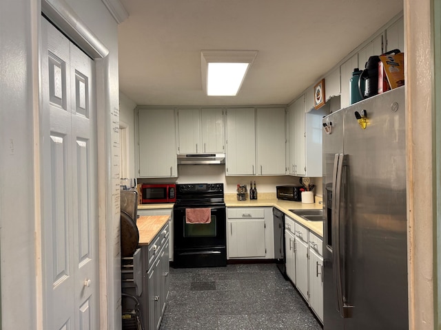 kitchen with black appliances, under cabinet range hood, and a sink