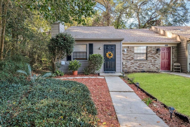 ranch-style home featuring a front yard