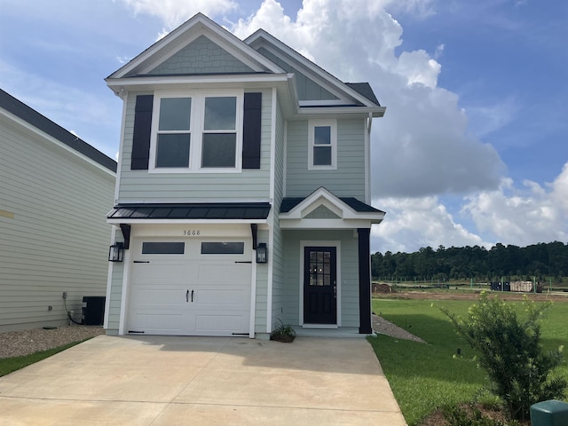 view of front of home featuring central AC unit, a garage, and a front lawn