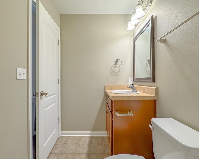 2027 Ann Arbor Ave Unit 1501, Tallahassee, FL 32304 - half bathroom featuring toilet, vanity, tile patterned flooring, and baseboards