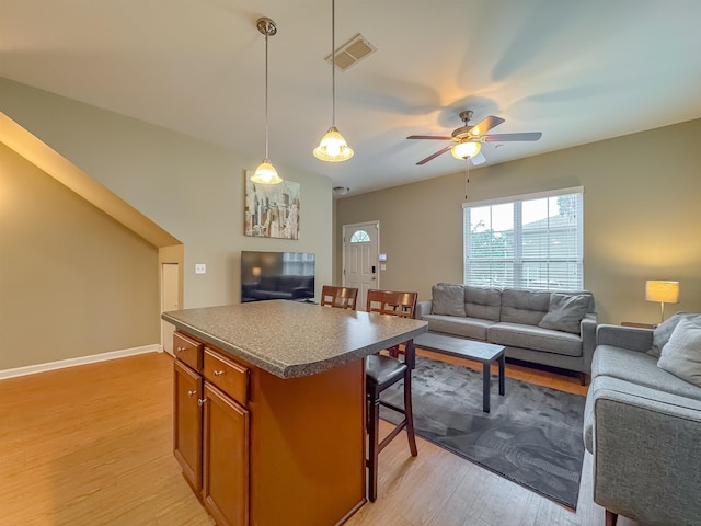 2027 Ann Arbor Ave Unit 1501, Tallahassee, FL 32304 - living room with light wood-style floors, a ceiling fan, and baseboards