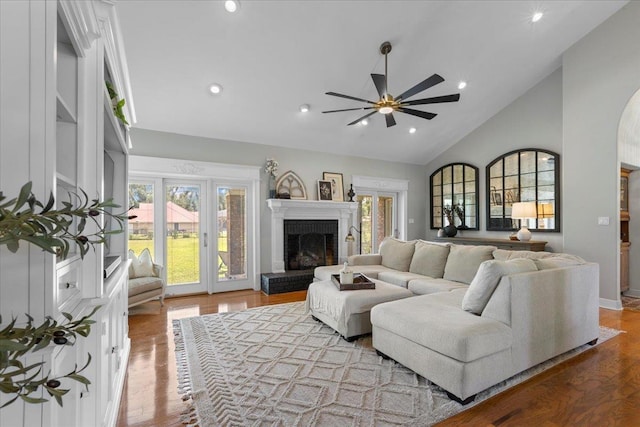 411 Worley Way, Perry, FL 32347 - living area with a brick fireplace, ceiling fan, wood finished floors, recessed lighting, and high vaulted ceiling