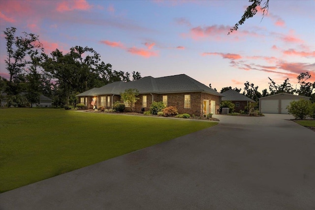 411 Worley Way, Perry, FL 32347 - ranch-style house featuring an outdoor structure, a yard, a detached garage, and driveway