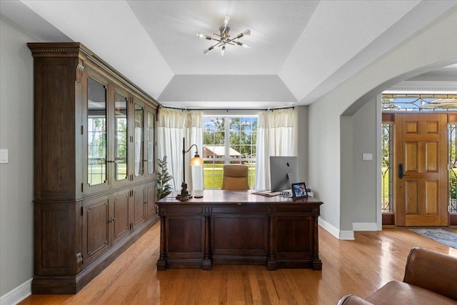 411 Worley Way, Perry, FL 32347 - office space with arched walkways, light wood-style flooring, a chandelier, and vaulted ceiling