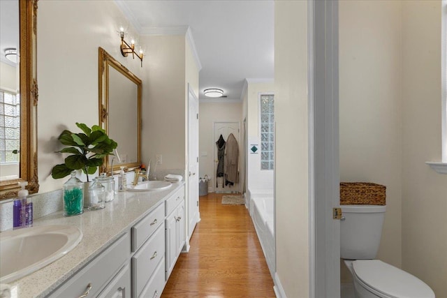 411 Worley Way, Perry, FL 32347 - bathroom with crown molding, double vanity, wood finished floors, and a tub to relax in