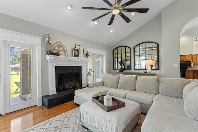 411 Worley Way, Perry, FL 32347 - living area with a ceiling fan, wood finished floors, healthy amount of natural light, a fireplace, and high vaulted ceiling