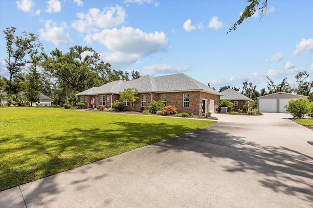 411 Worley Way, Perry, FL 32347 - ranch-style home featuring a detached garage, a front lawn, an outbuilding, and brick siding