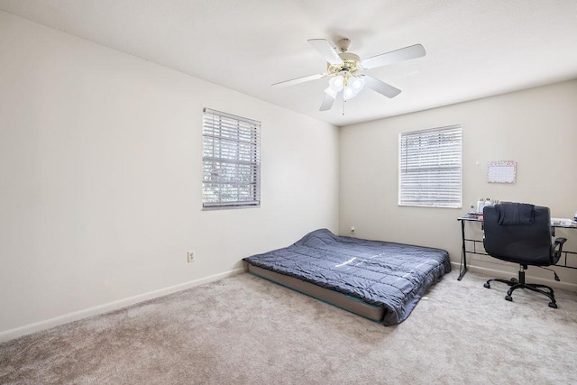 carpeted bedroom with ceiling fan and multiple windows