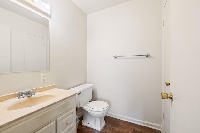 bathroom with vanity, hardwood / wood-style flooring, and toilet