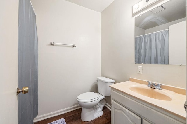 bathroom with vanity, hardwood / wood-style flooring, and toilet