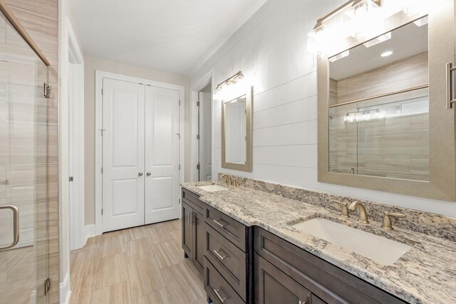 bathroom featuring an enclosed shower and vanity