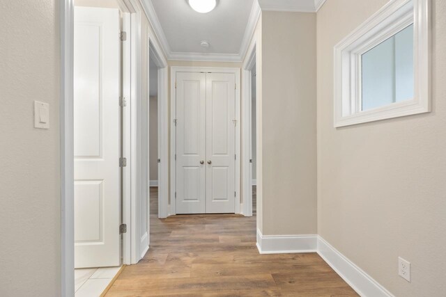 corridor featuring light hardwood / wood-style floors and ornamental molding