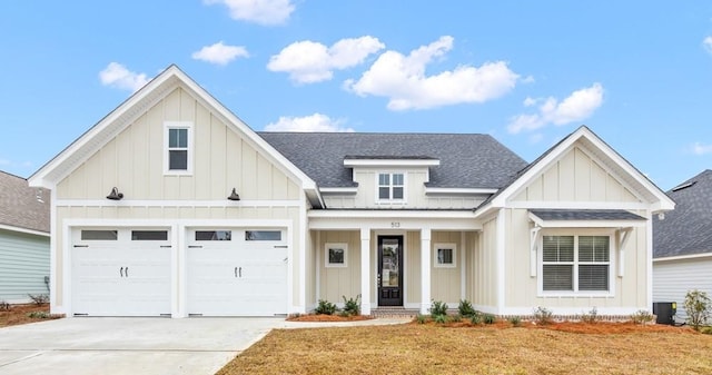 view of front facade with a front lawn, central air condition unit, a garage, and a porch