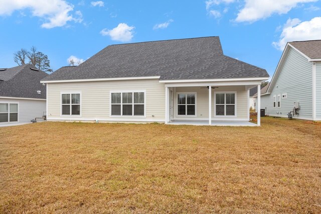 back of house featuring a yard and a patio