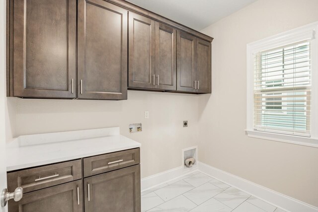 laundry area featuring hookup for an electric dryer, washer hookup, and cabinets