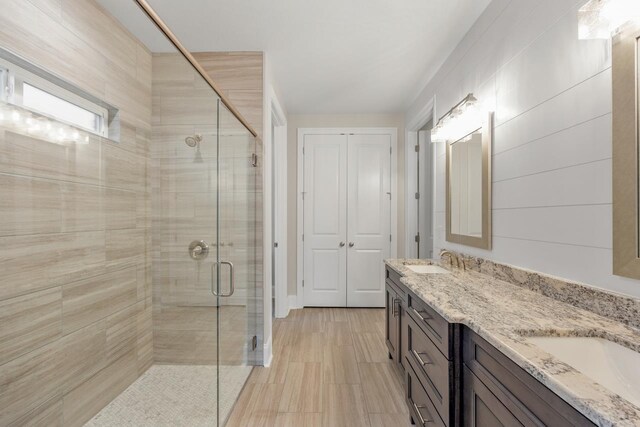 bathroom featuring walk in shower and vanity