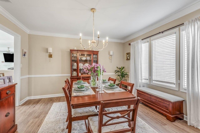 dining area with a notable chandelier, crown molding, and light wood-type flooring