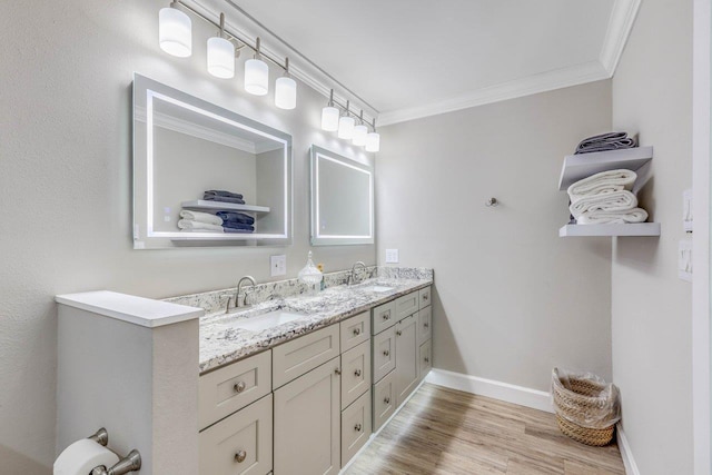 bathroom featuring hardwood / wood-style flooring, ornamental molding, and vanity