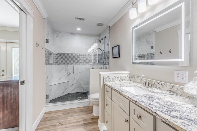 bathroom featuring toilet, an enclosed shower, ornamental molding, vanity, and hardwood / wood-style floors