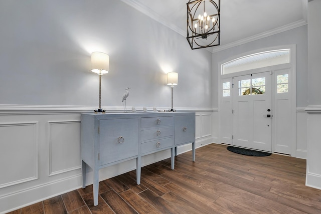 foyer featuring ornamental molding and dark hardwood / wood-style floors