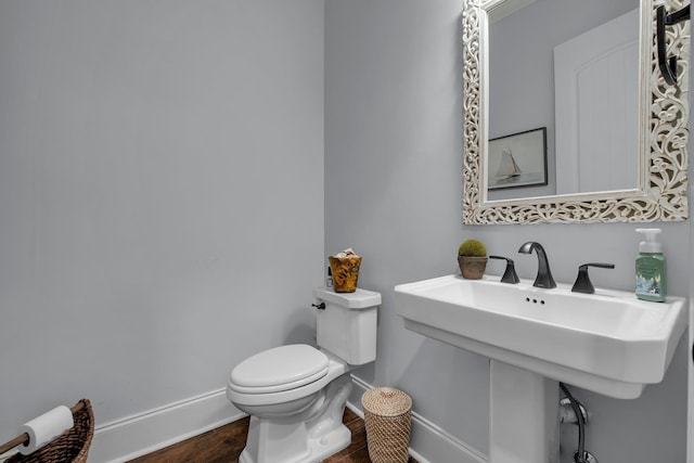 bathroom with toilet and hardwood / wood-style floors