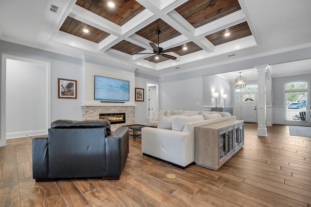 living room with coffered ceiling, crown molding, hardwood / wood-style flooring, a fireplace, and decorative columns