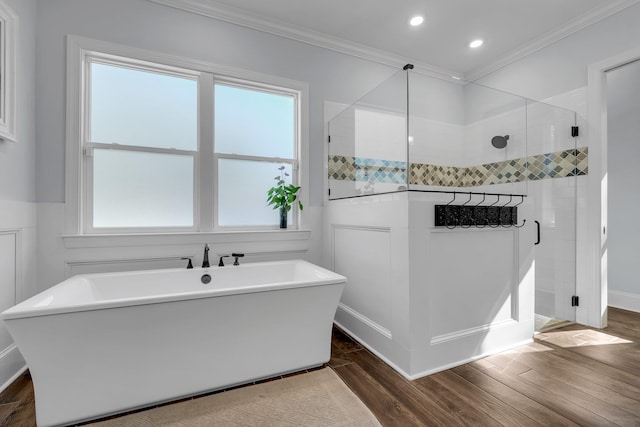 bathroom featuring hardwood / wood-style floors, ornamental molding, and plus walk in shower