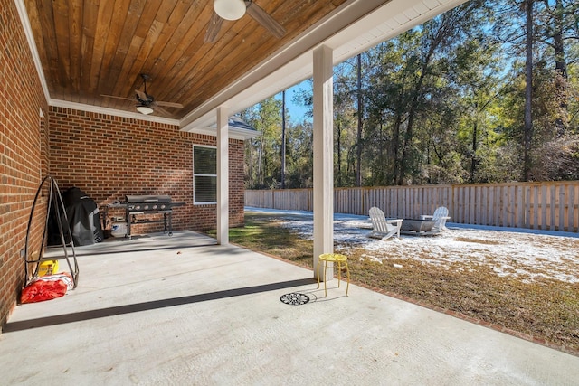 view of patio / terrace with ceiling fan, grilling area, and a fire pit