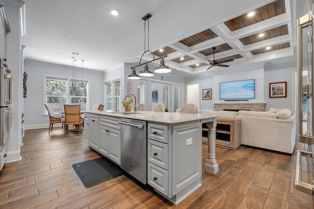 kitchen with sink, dark wood-type flooring, dishwasher, an island with sink, and decorative light fixtures