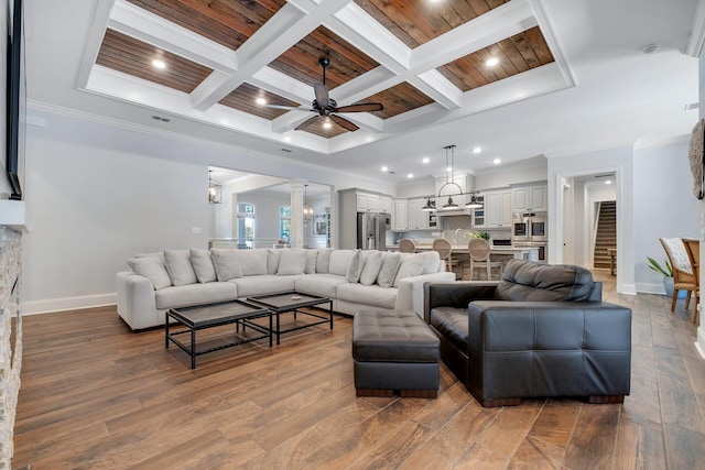 living room with crown molding, wood ceiling, coffered ceiling, and ceiling fan