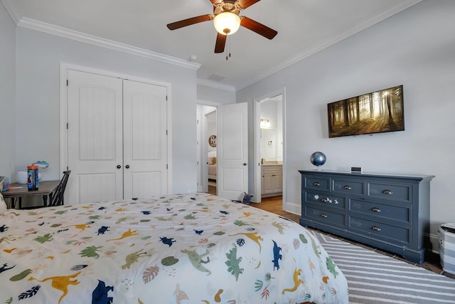 bedroom with ornamental molding, ensuite bathroom, ceiling fan, and a closet