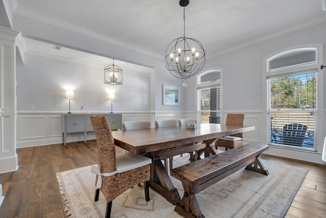 dining area featuring crown molding, hardwood / wood-style floors, and a notable chandelier