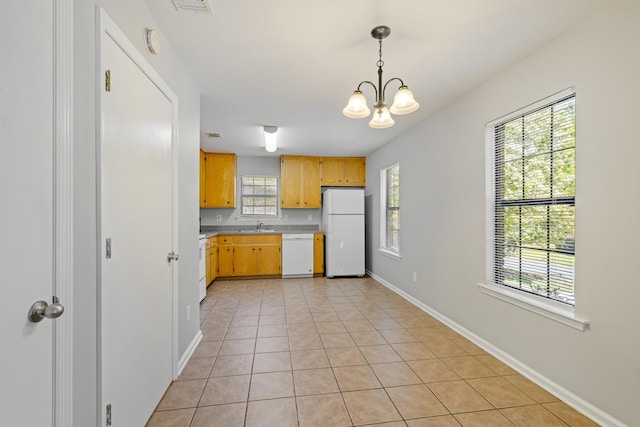 kitchen featuring white appliances, light tile patterned floors, light countertops, baseboards, and a notable chandelier
