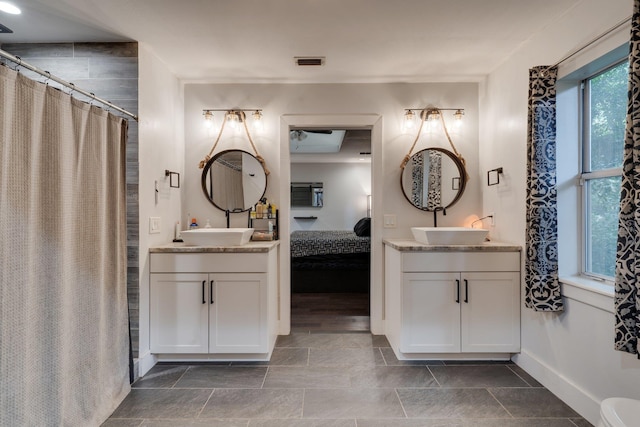 2414 Glenshire Ln, Tallahassee, FL 32308 - ensuite bathroom featuring baseboards, two vanities, and a shower with shower curtain
