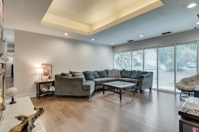 2414 Glenshire Ln, Tallahassee, FL 32308 - living room with wood finished floors, a tray ceiling, recessed lighting, and baseboards